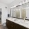 View of a modern and bright luxury bathroom with a walk-in closet in an apartment for rent in Fort Worth. 