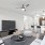 A large white sofa facing a flat-screen television in a modern one-bedroom apartment for rent in Fort Worth.