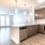 A North Fort Worth apartment for rent and a view of its sleek and modern kitchen, featuring wooden cabinetry.