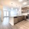 A North Fort Worth apartment for rent and a view of its sleek and modern kitchen, featuring wooden cabinetry.