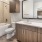 A sleek bathroom with wooden finishes in a Fort Worth luxury apartment for rent at the Holston.