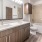 A sleek bathroom with wooden finishes and two sinks in a Fort Worth luxury apartment for rent.