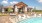 The pool area at our apartments for rent in North Fort Worth, featuring a clubhouse and chairs in the pool.