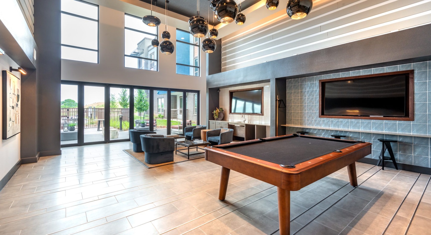 room with a pool table and wall mounted tv