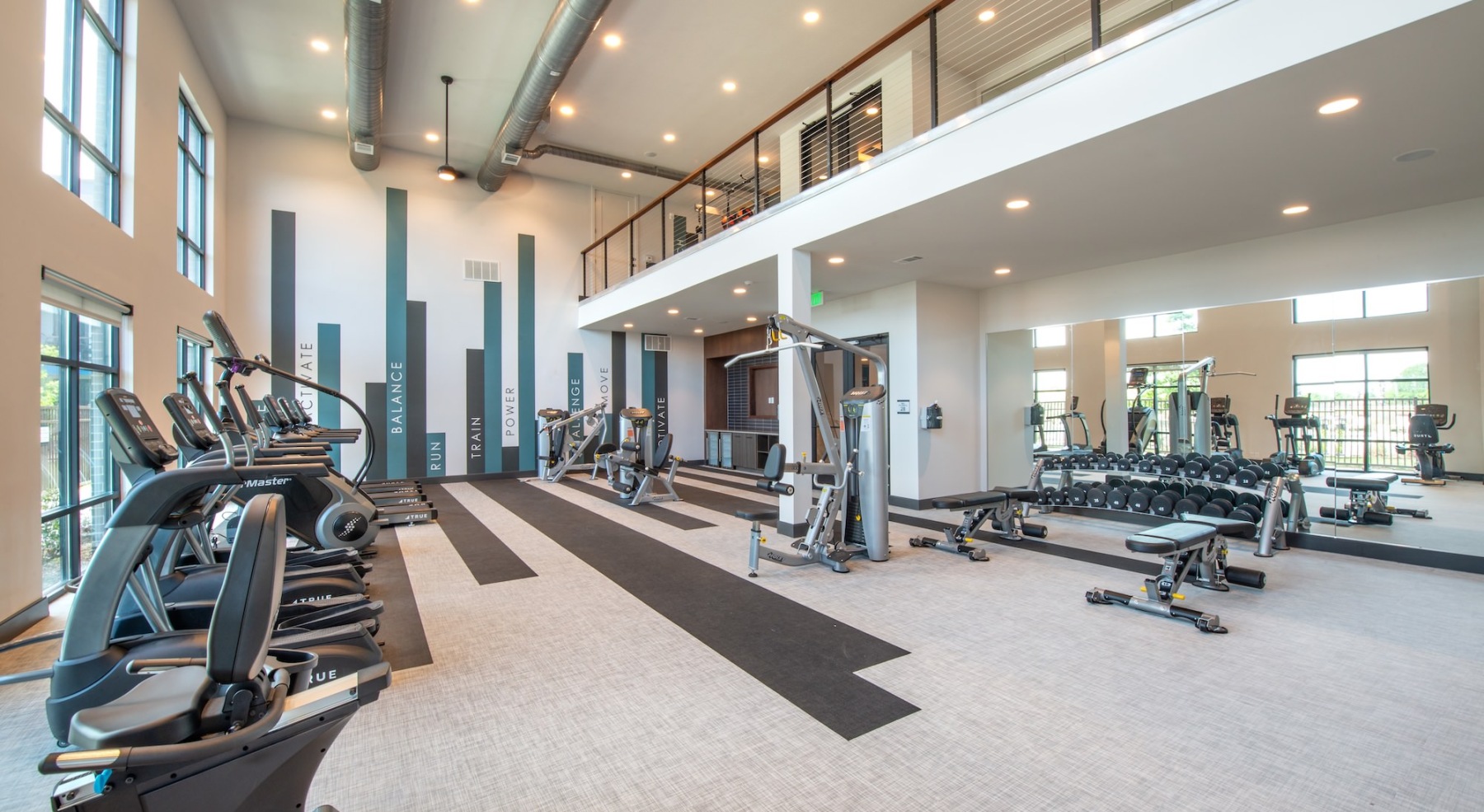 fitness center with treadmills and free weights