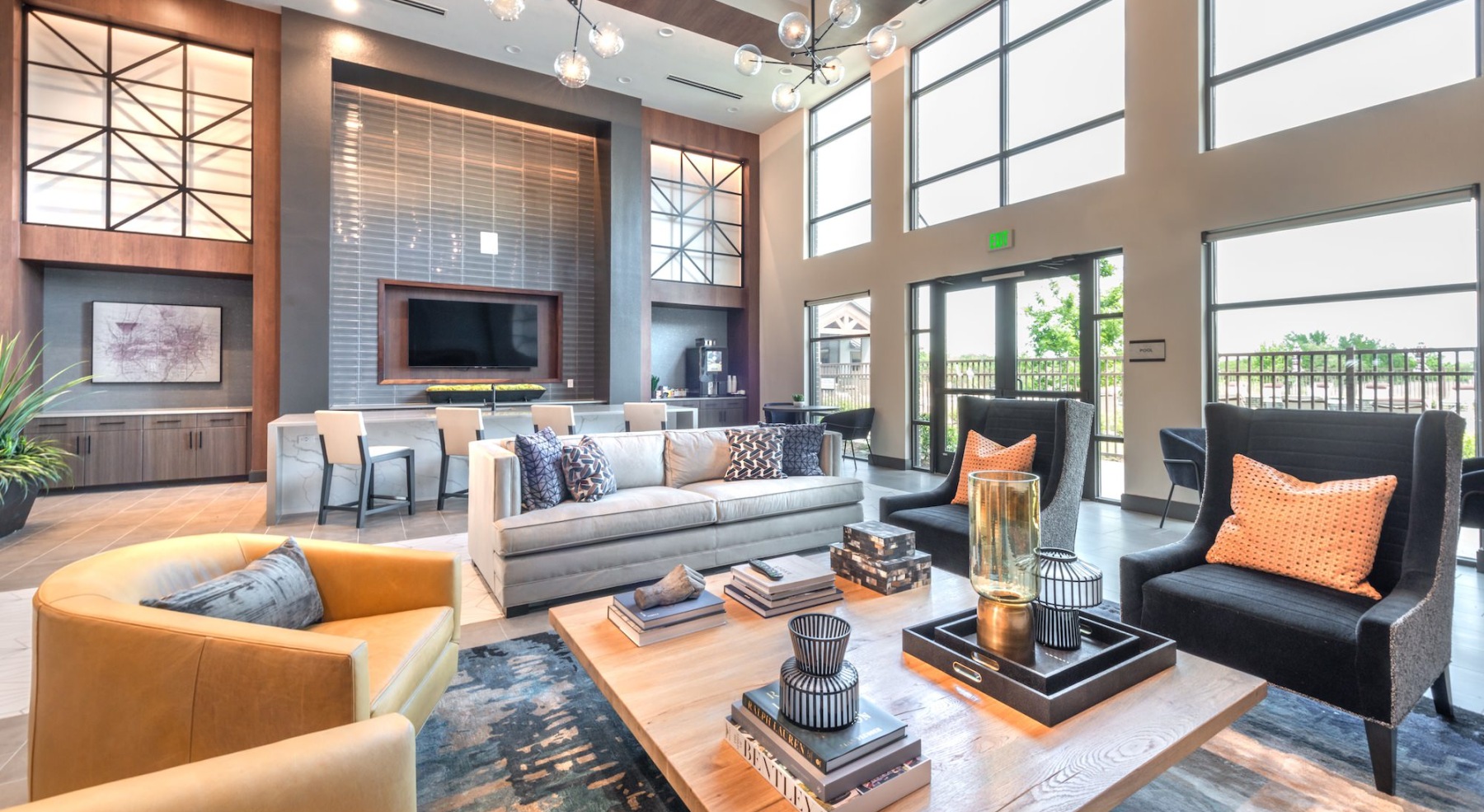 room with couch chairs coffee table with books and a candle