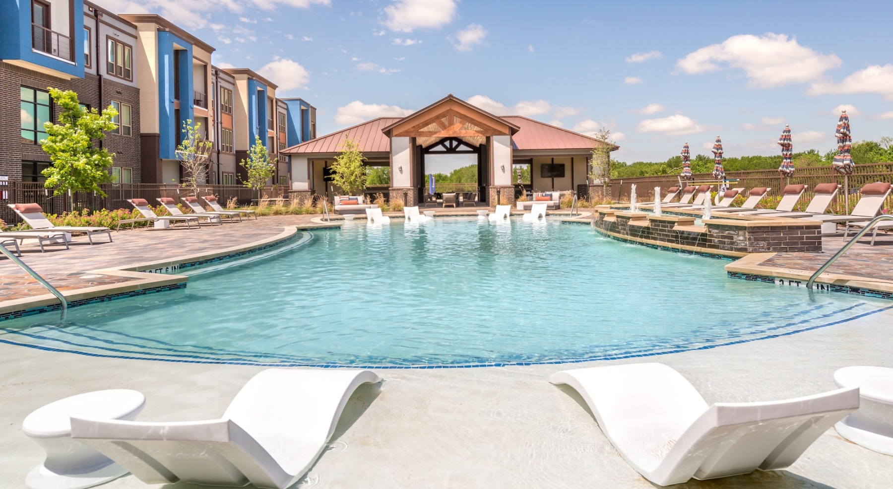 a pool with two lounge chairs 